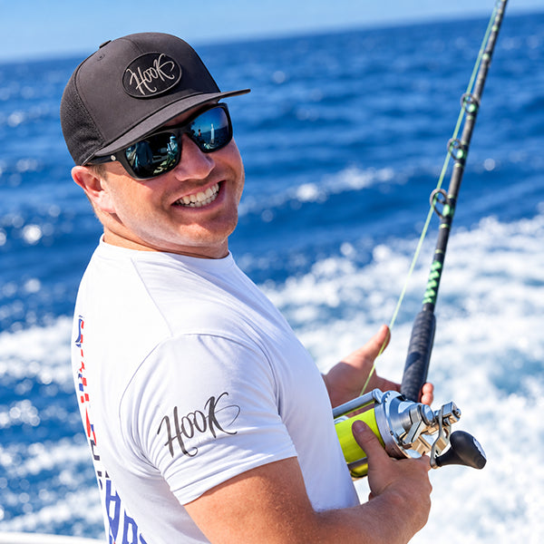 captain wearing hook optics sunglasses on the water catching fish