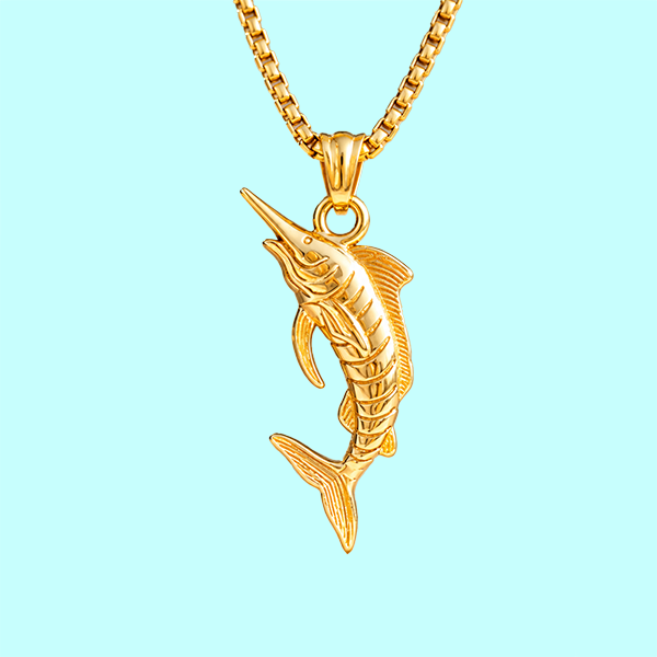 A gold-tone marlin pendant necklace on a matching box chain, shown against a solid light blue background.
