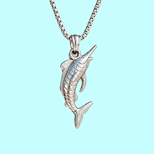 A silver-toned marlin pendant necklace on a matching box chain, shown against a solid light aqua background.