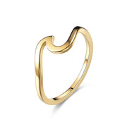 Gold ring with a curved design on a white background sold by Hook Optics 